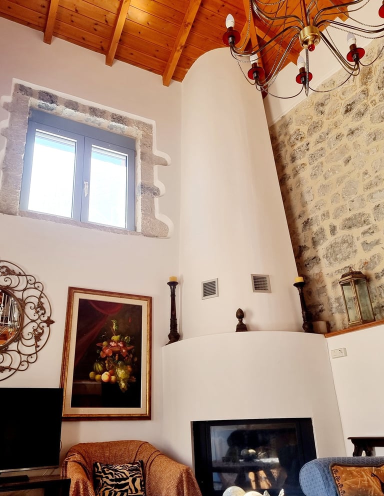 a living room with a fireplace and a chandelier