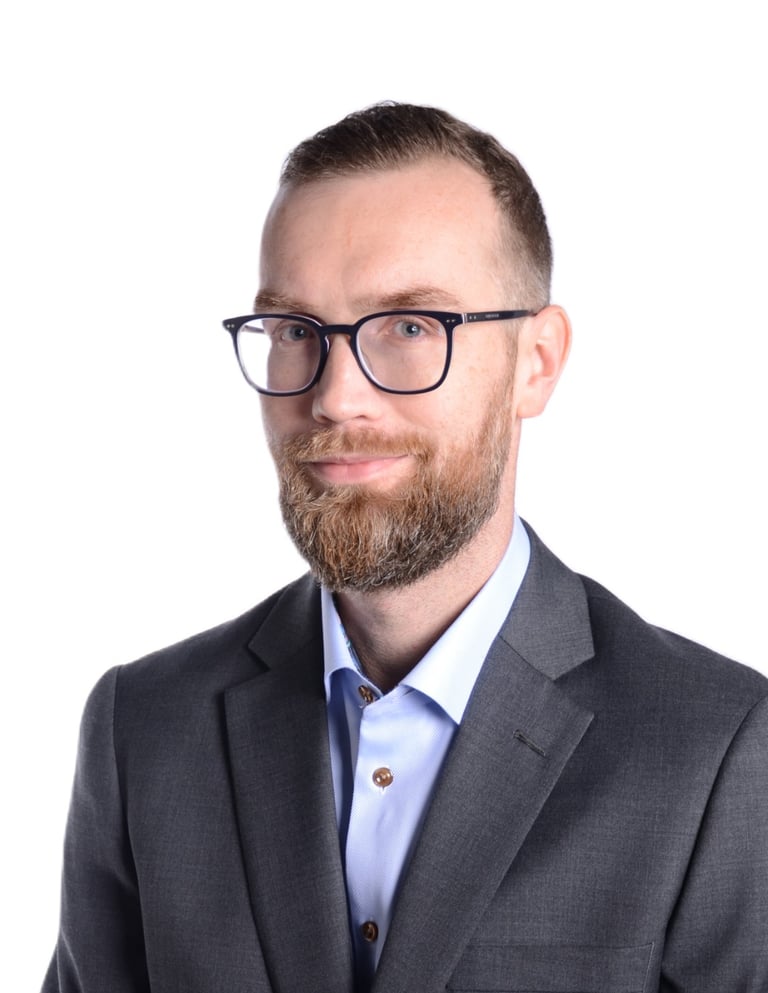 a man in a suit and glasses posing for a picture