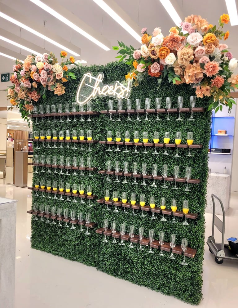 doubl champagne wall of flowers and wine glasses on display