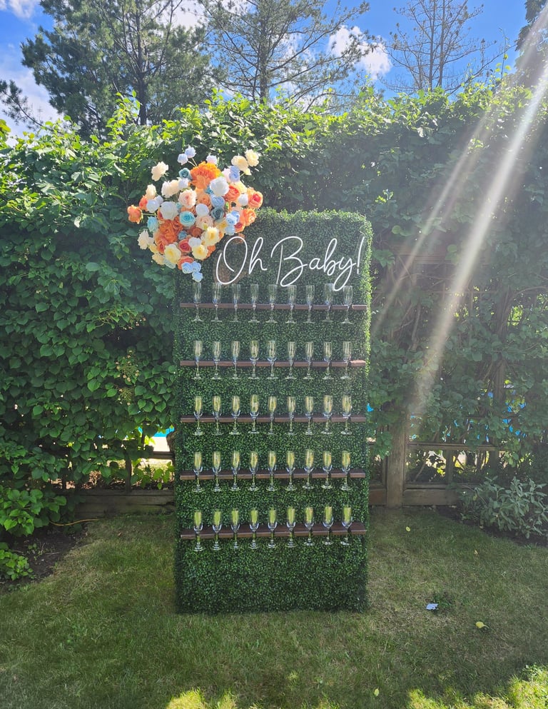 grass champagne wall with tropical floral arrangement