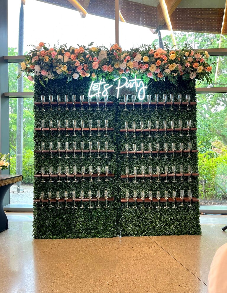 a wall of wine glasses with a green champagne wall wall
