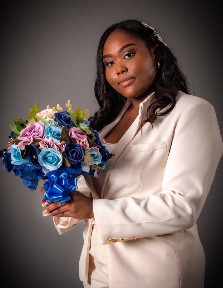a woman in a white suit and a bouquet of flowers