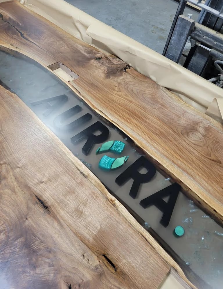 Custom Black Walnut boardroom table featuring a black epoxy river and natural live edge slabs