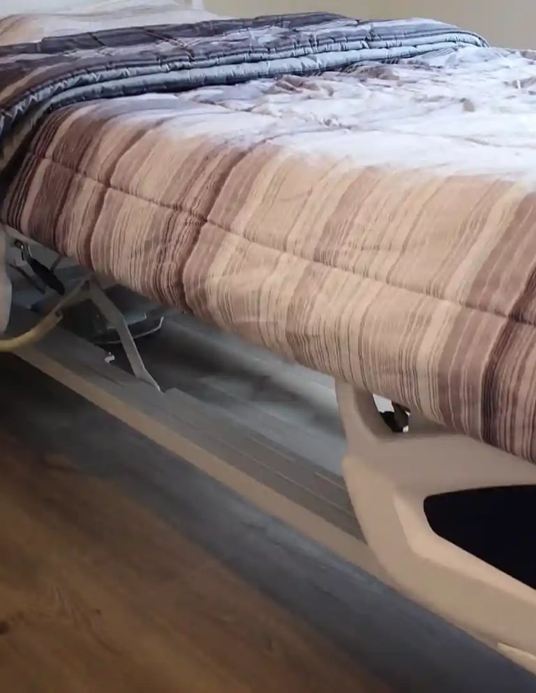 Adjustable medical bed in a comfortable AFH room, supporting safe rest, mobility, and daily care for residents.