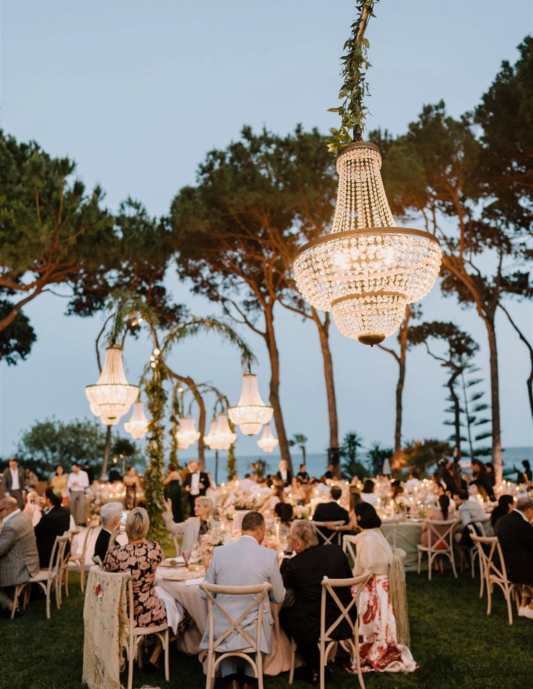 Evening gala dinner under chandeliers by the sea