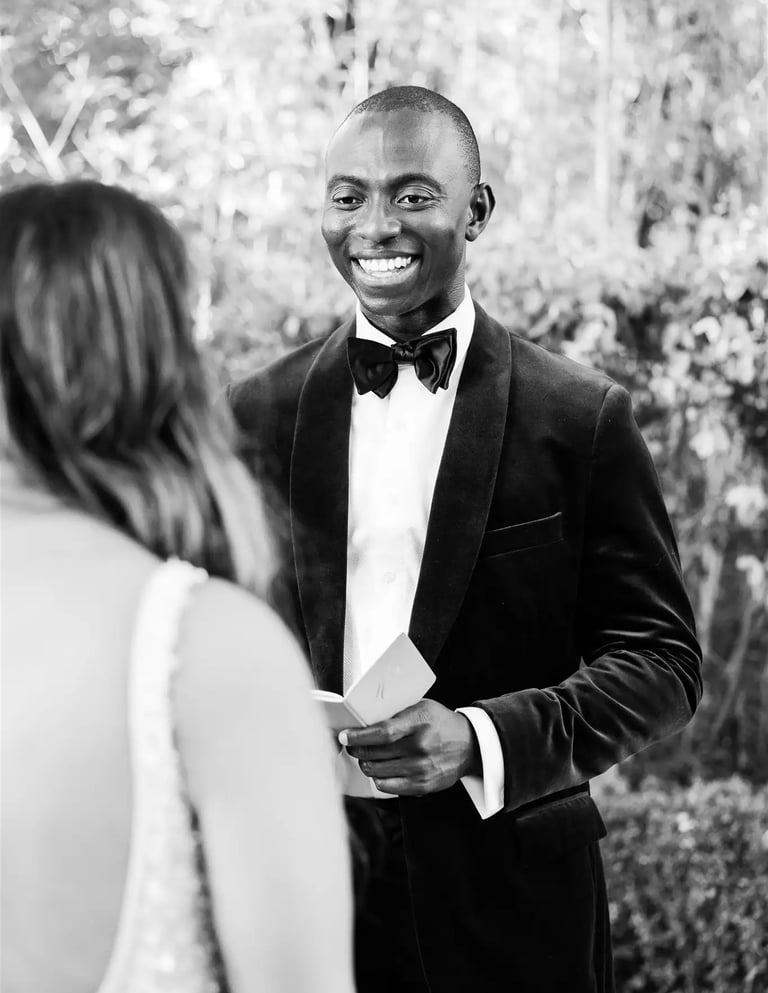 Black and white photo of groom reading vows during elopement ceremony in Provence
