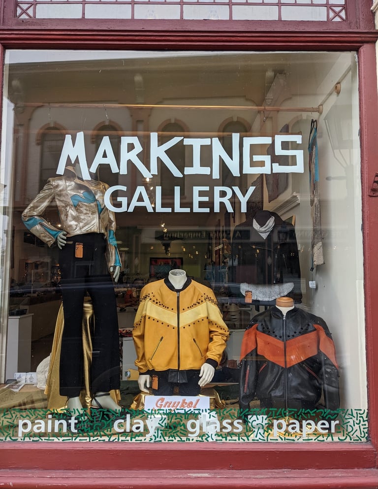 A photo of a front window of Markings Gallery
