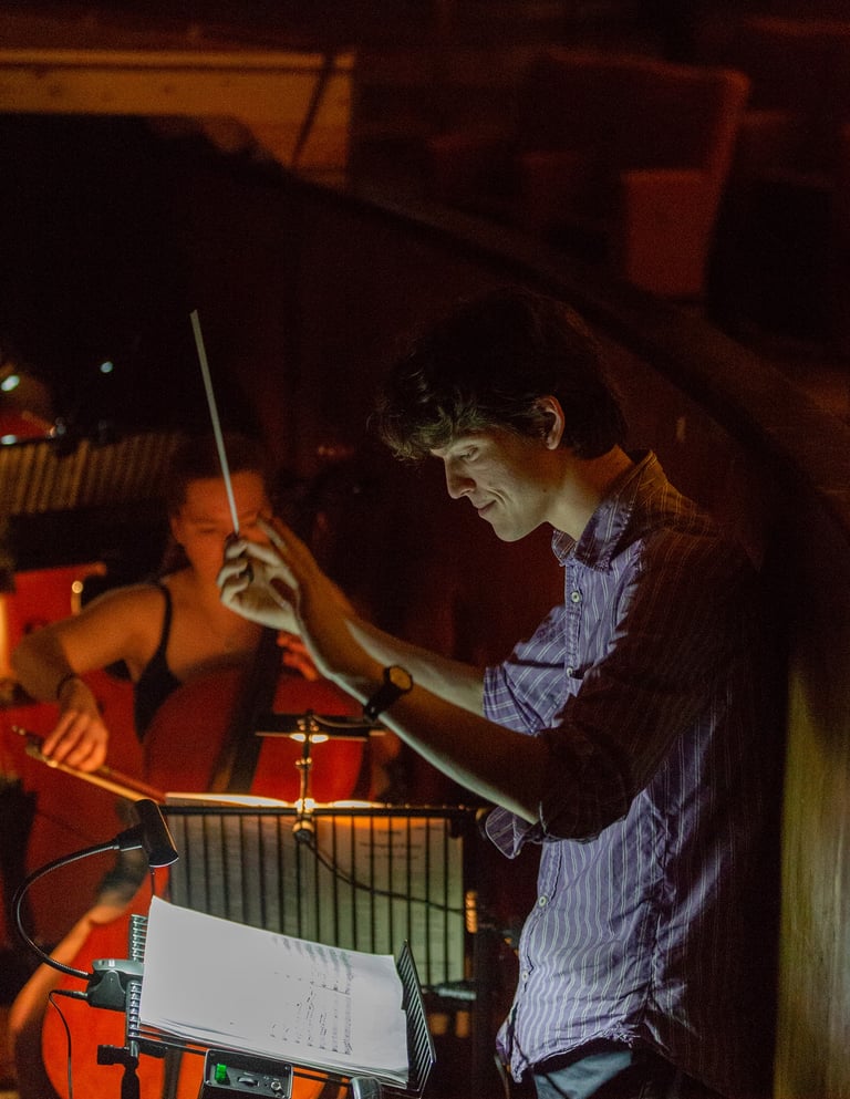 David Rice conducting in an orchestra pit