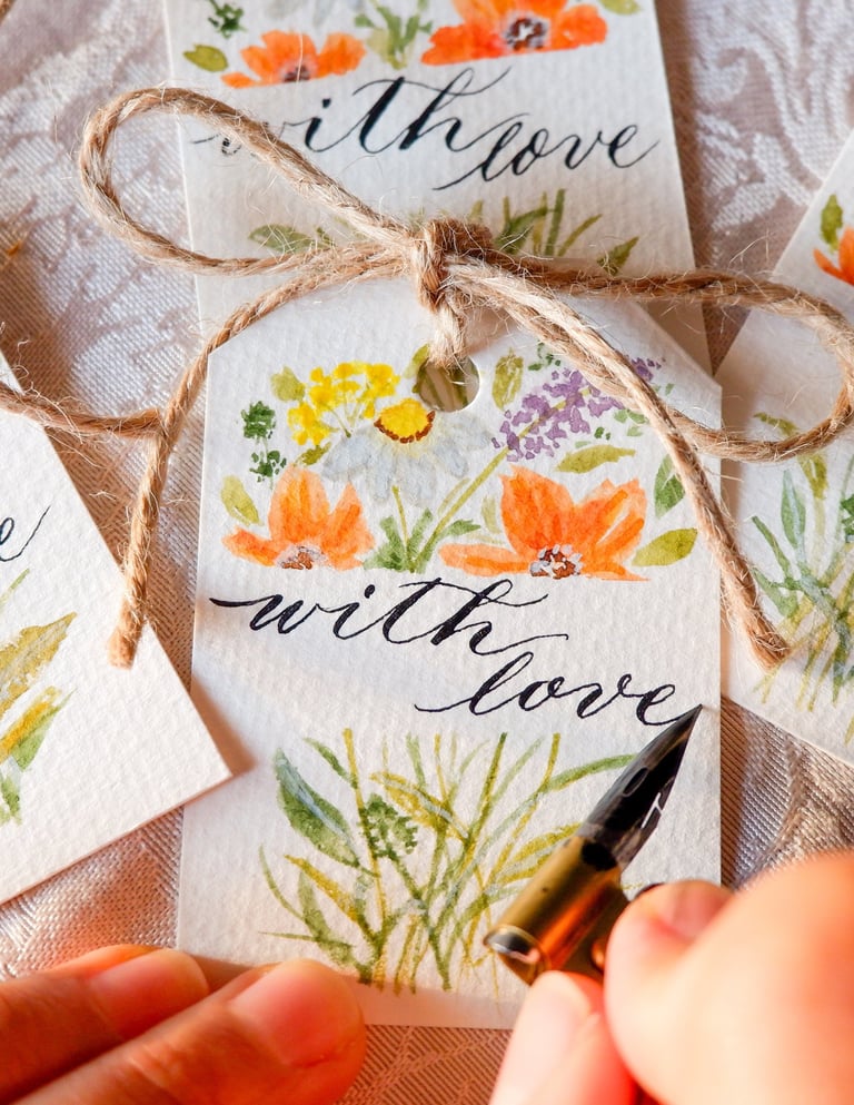 NYC calligrapher writing custom gift tags for a live event.