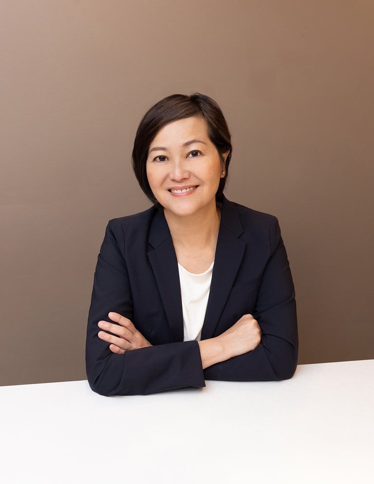 a woman in a suit and white shirt smiling