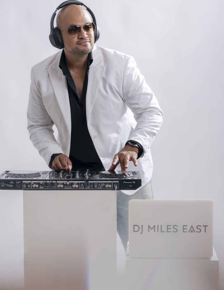 a dj in a white jacket and headphones