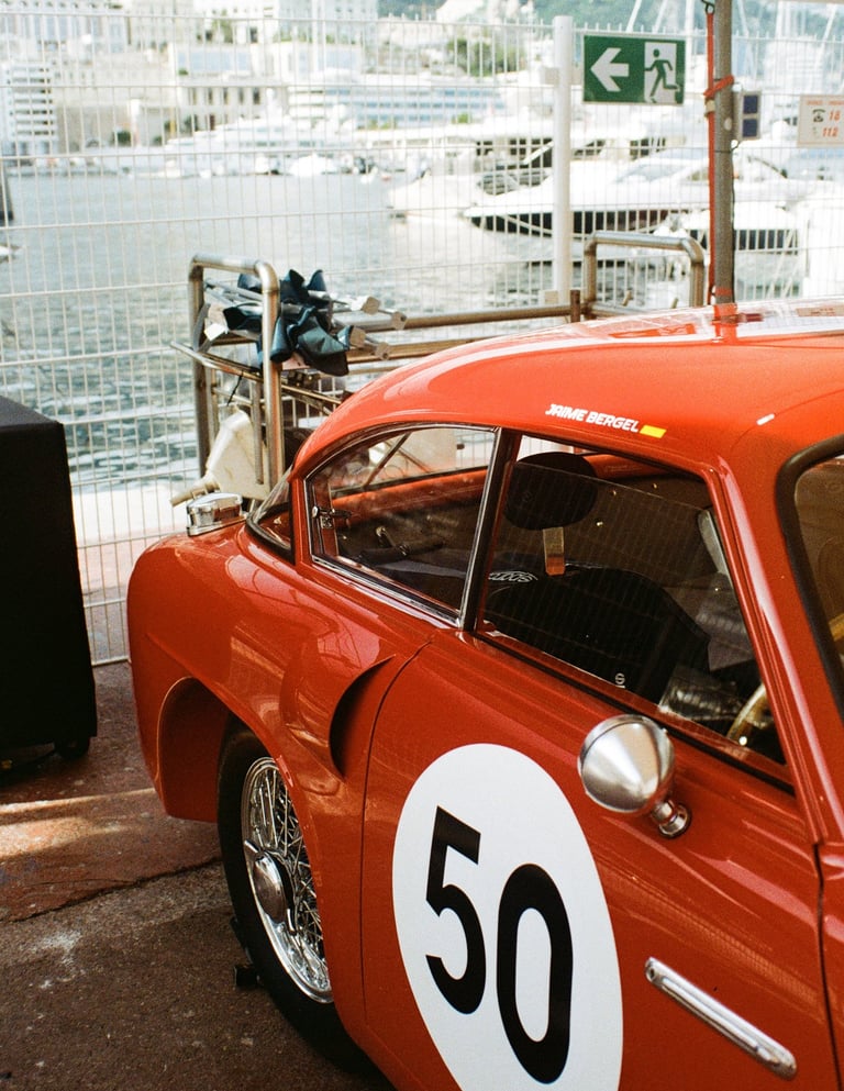 a red race car parked in the paddock