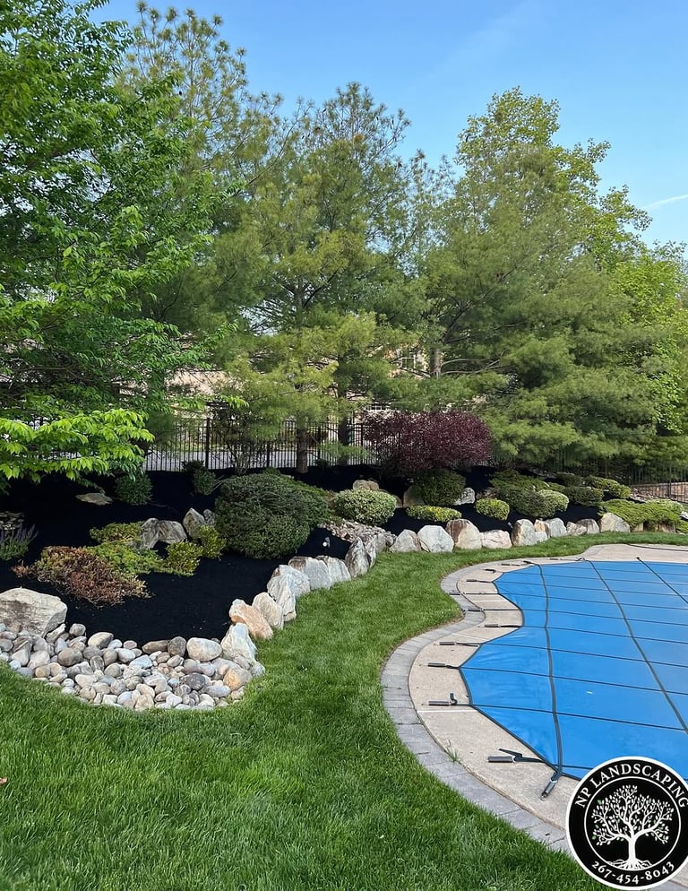 excellent landscaping and hardscaping of grass, stones and trees by NP Landscaping