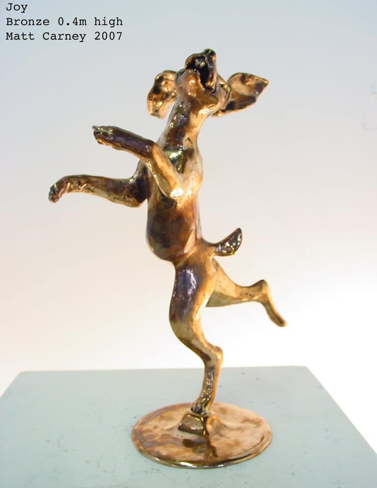a bronze sculpture of a joyful rabbit