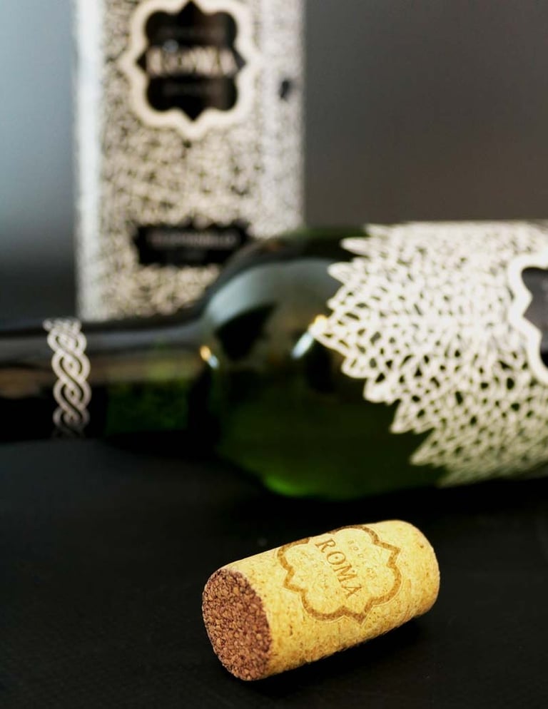 Close up of two wine bottles and a cork