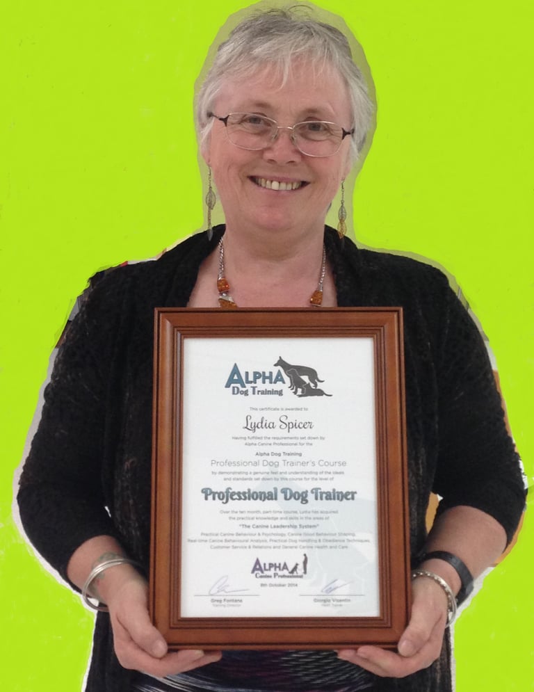 Dog Manners owner holding Professional Dog Trainer certificate