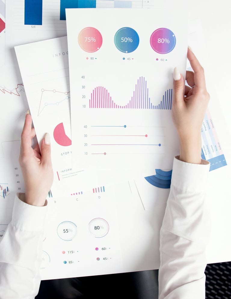 Professional analyzing financial data reports with colorful charts and business infographics.