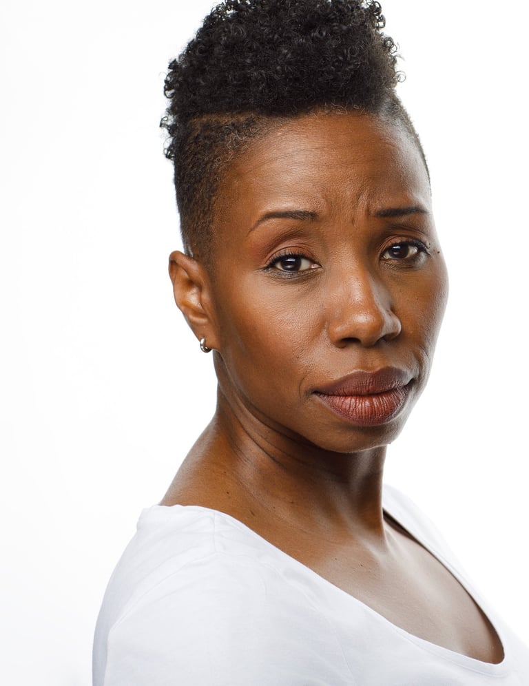 Headshot of Tracie Frank looking over her shoulder with a concerned expression.
