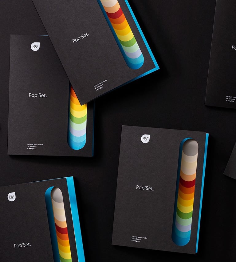 product photography - a group of four different coloured booklets