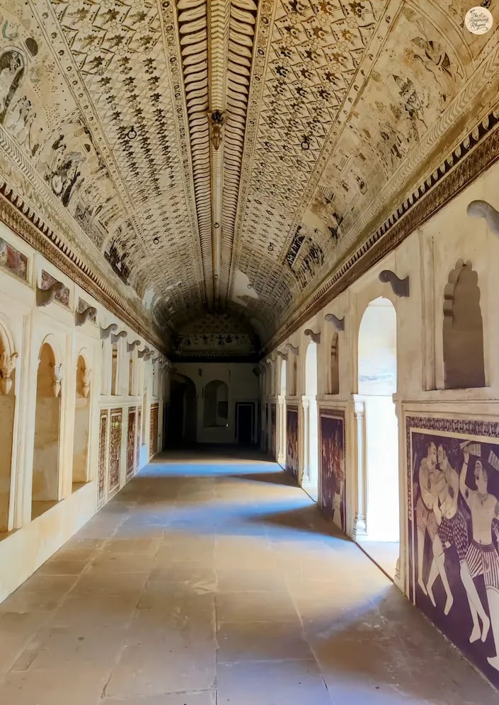 ainted gallery of Lakshmi Temple, Orchha, featuring mythological frescoes and Bundela artistry.