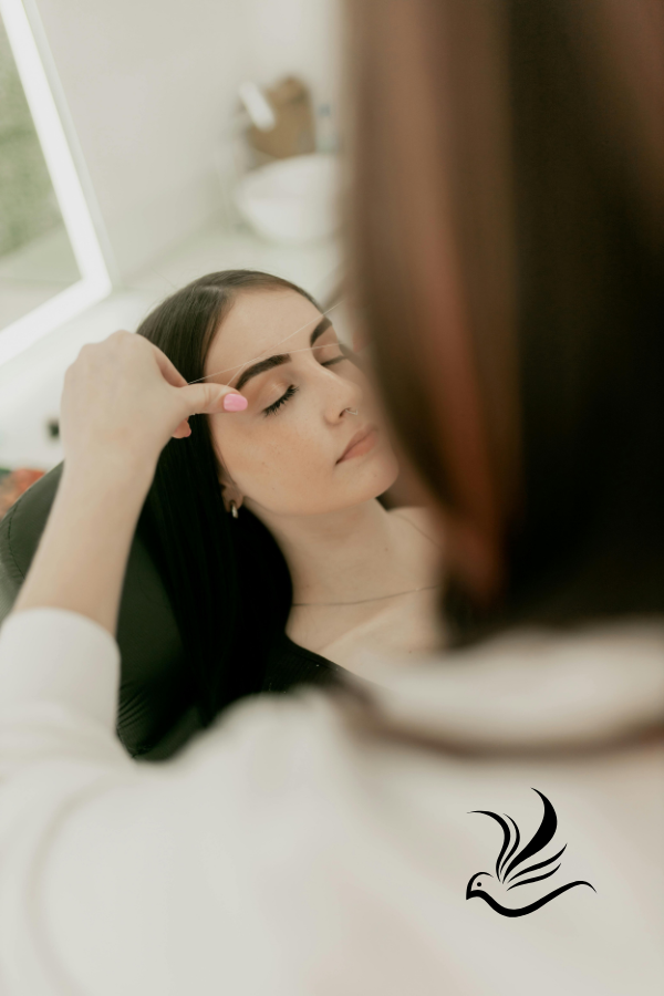 a woman is shown in a mirror while she is getting her hair done