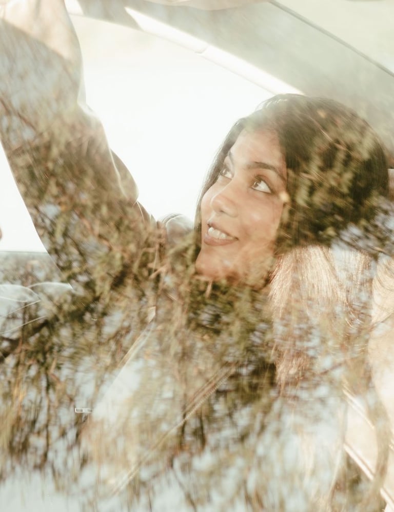 a woman in a car looking happy