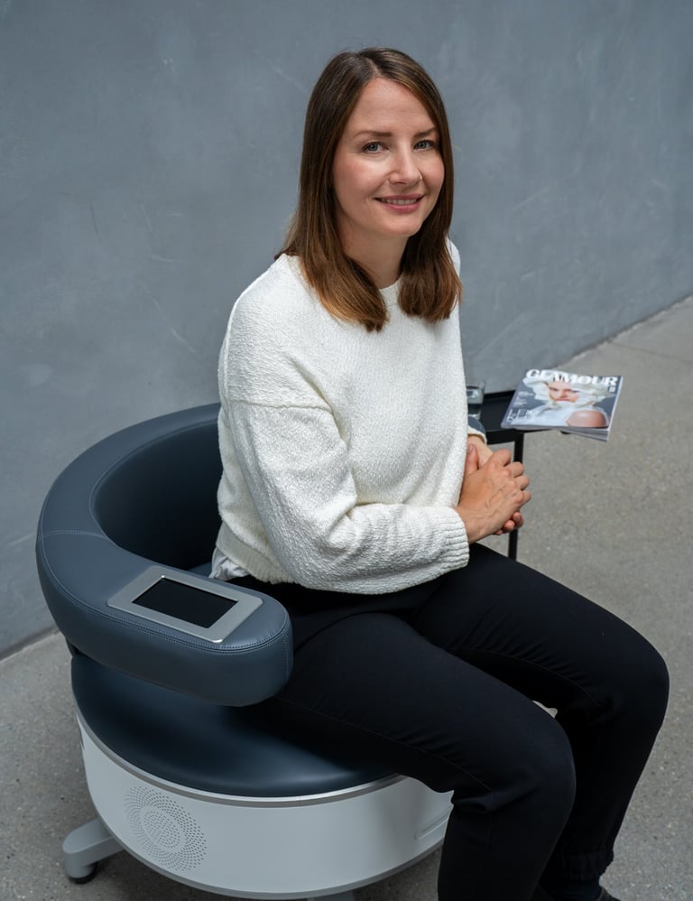a woman sitting in a chair with a magazine on it