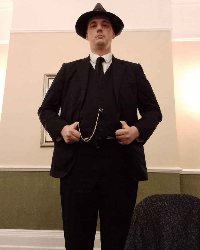 man dressed as an older style police detective