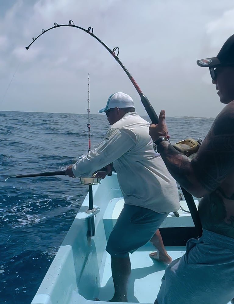 a man fishing in the ocean with a fishing rod