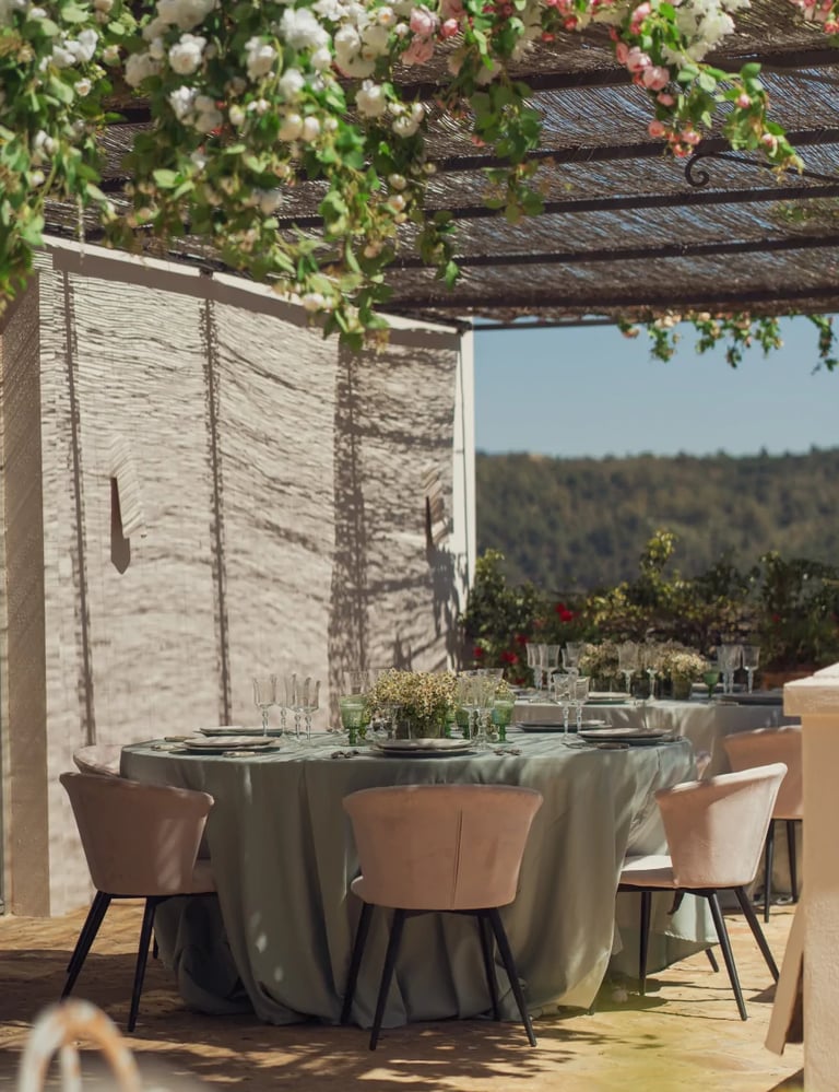 Outdoor dining table under vines at Finca Santa Katerina