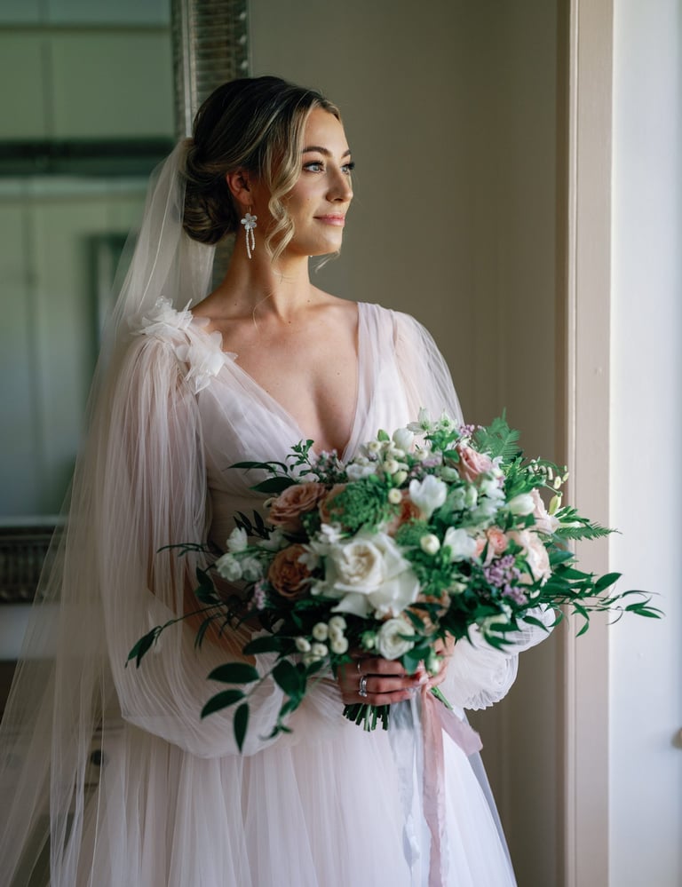 a bride in a wedding dress holding a bouquet