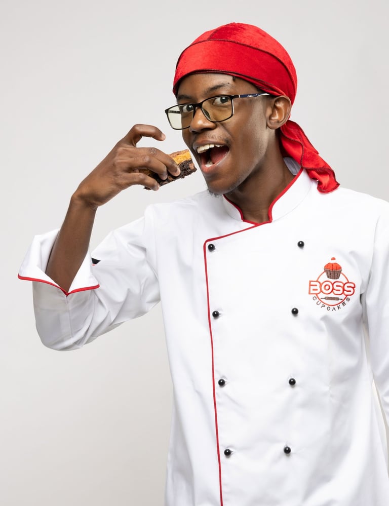 a man in a chef's uniform is holding a cookie
