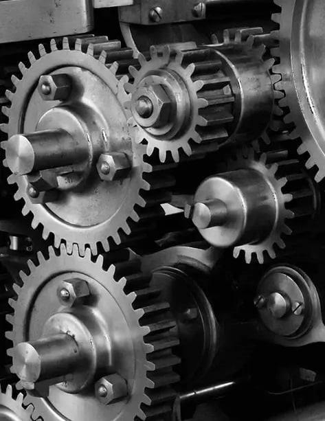 Uma máquina que fabrica sacos de papel com diversas engrenagens.