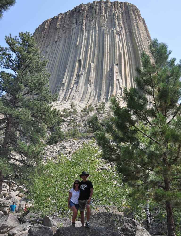 couple standing in front of devils tower, wyoming