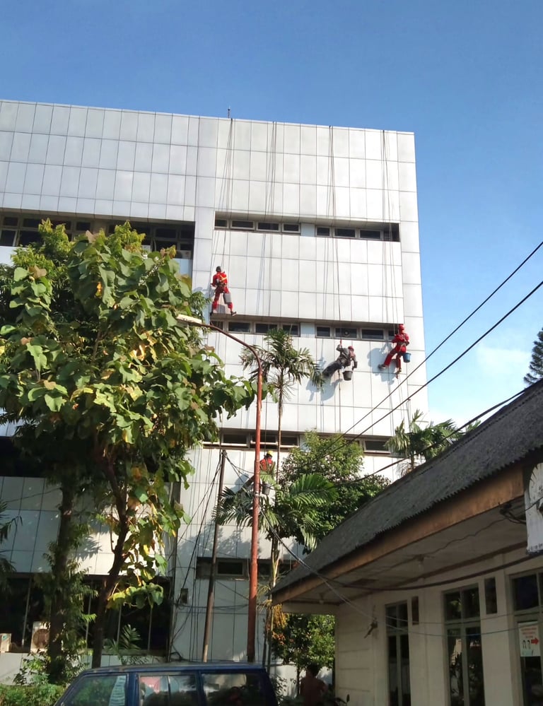 a man on a ladder in a building