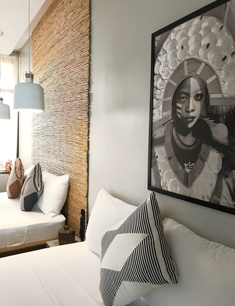 a bedroom with a large picture frame and a large picture of a woman's