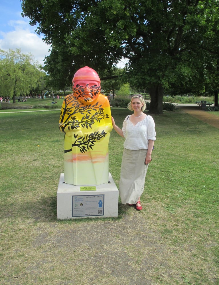 A sculpture for the Baron's trail painted with a sunset and silhouette tree