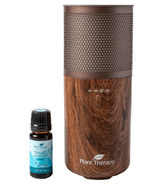 a wooden diffuser with a bottle of essential oils