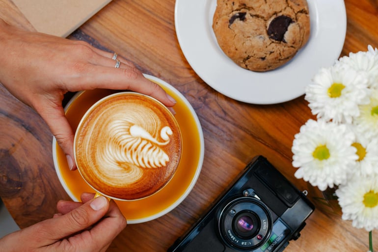 a person holding a cup of coffee in a cup