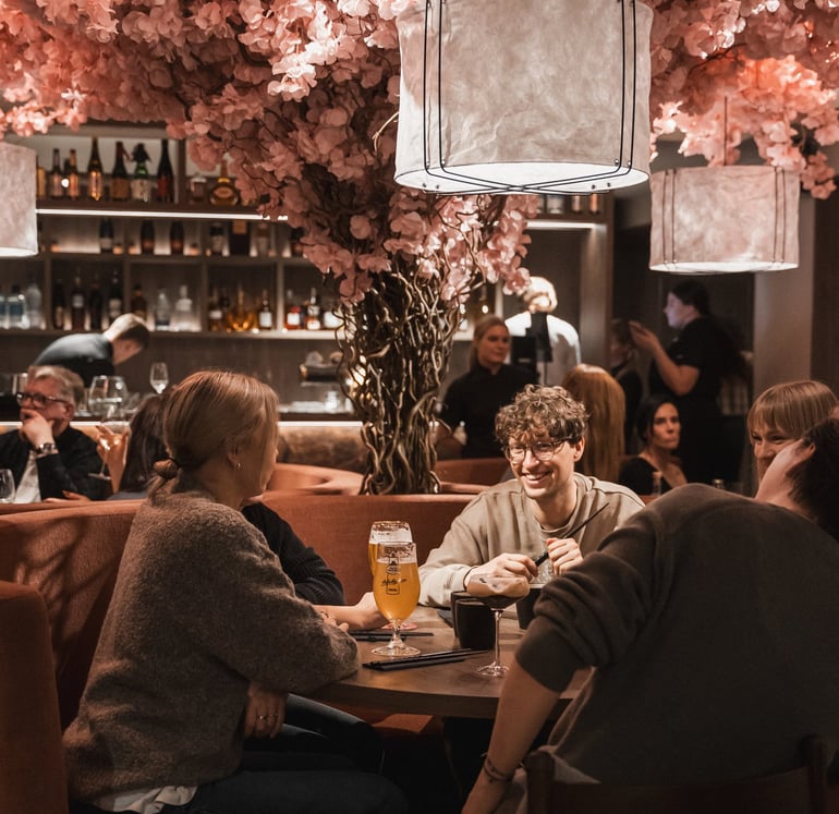 a group of people sitting at a table with drinks