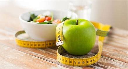 a green apple and a bowl of salad