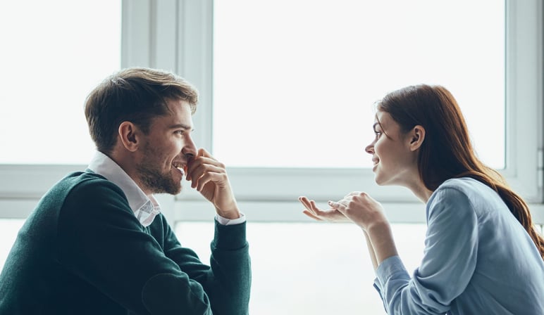 a man and woman sharing a meal at a restaurant