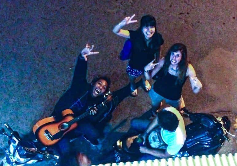 a group of people standing around a motorcycle