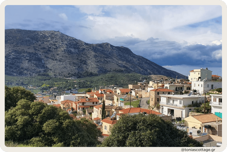 View of Archanes village with green landscapes, traditional old houses, and surrounding mountains