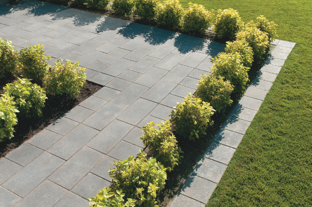 a garden with a brick wall and a brick wall