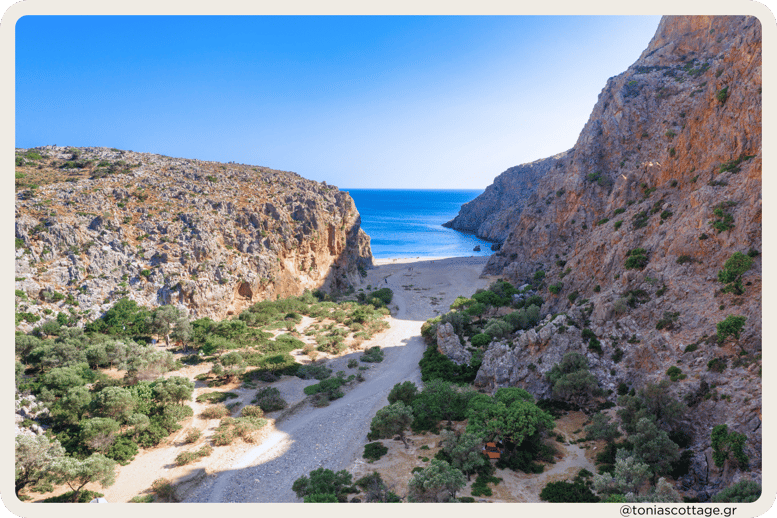 Entrance to Agiofarrago Beach and Gorge, Crete, Greece, where rugged cliffs meet the tranquil sea