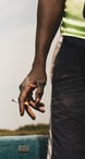 a man holding a cigarette in his hand