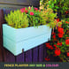 handmade planter box painted in blue with flowers and herbs
