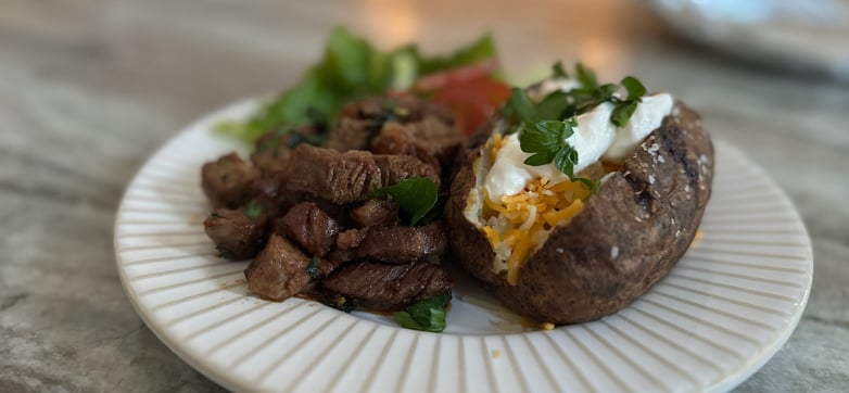 Air fryer steak bites with garlic butter and baked potatoes