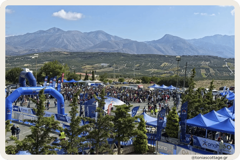 Crete Half Marathon organized event with participants, set against the backdrop of Cretan mountains